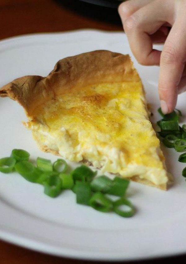 Serving Swiss Cheese Quiche on a big white plate