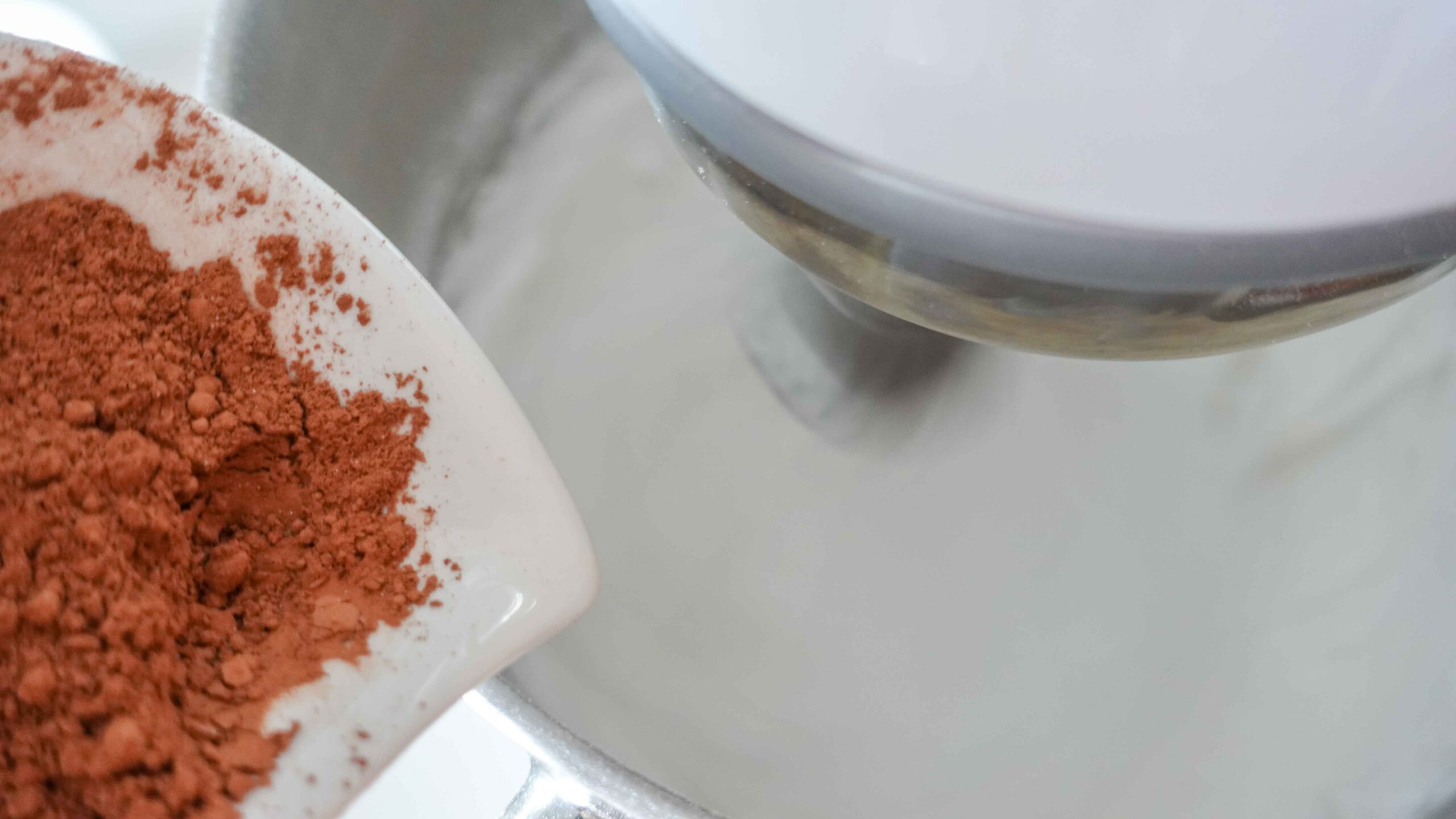 Adding cacao to a bowl with whipped egg whites