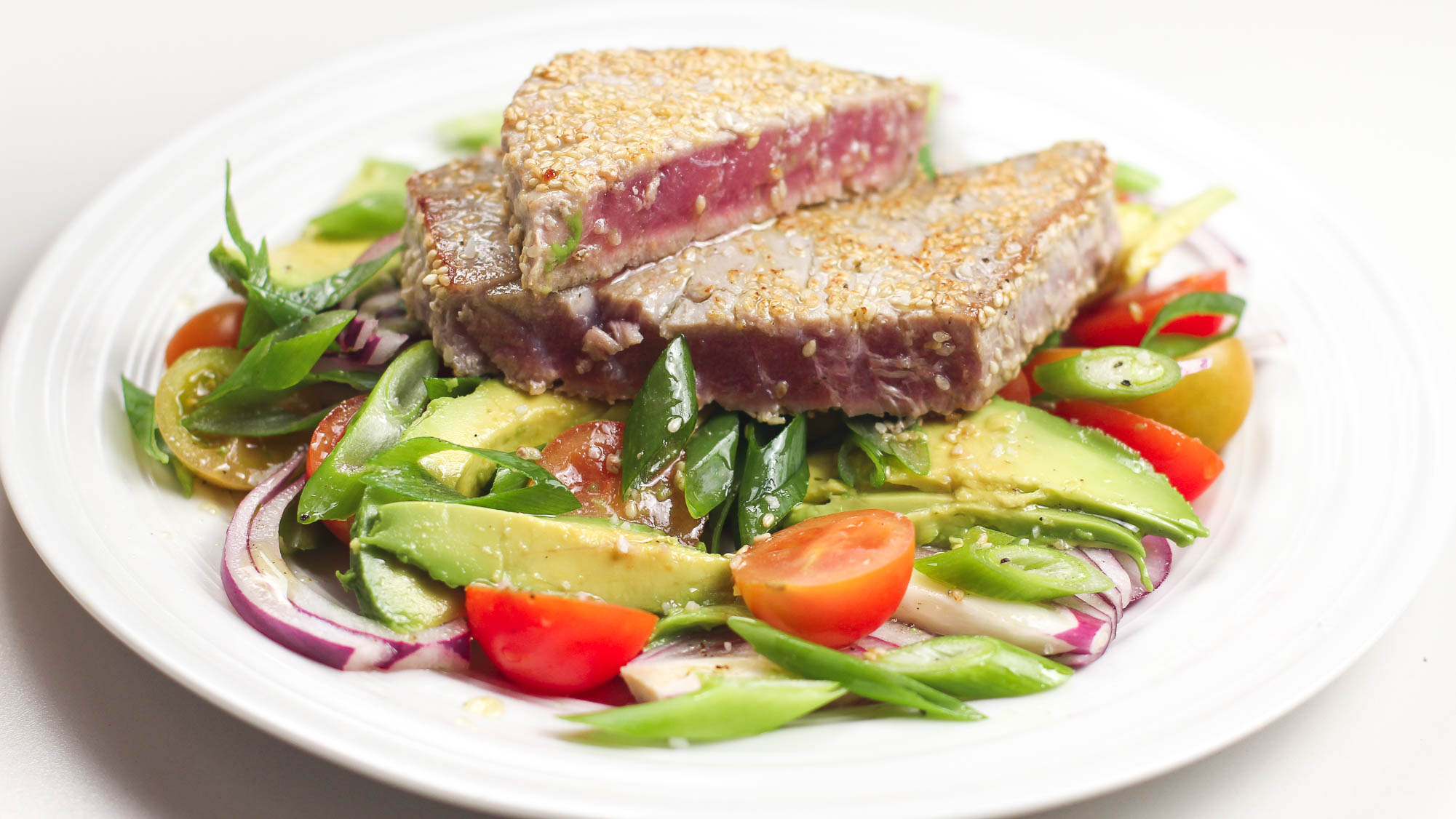 Delicious Ahi tUna Salad with Cherry tomatoes on a plate.
