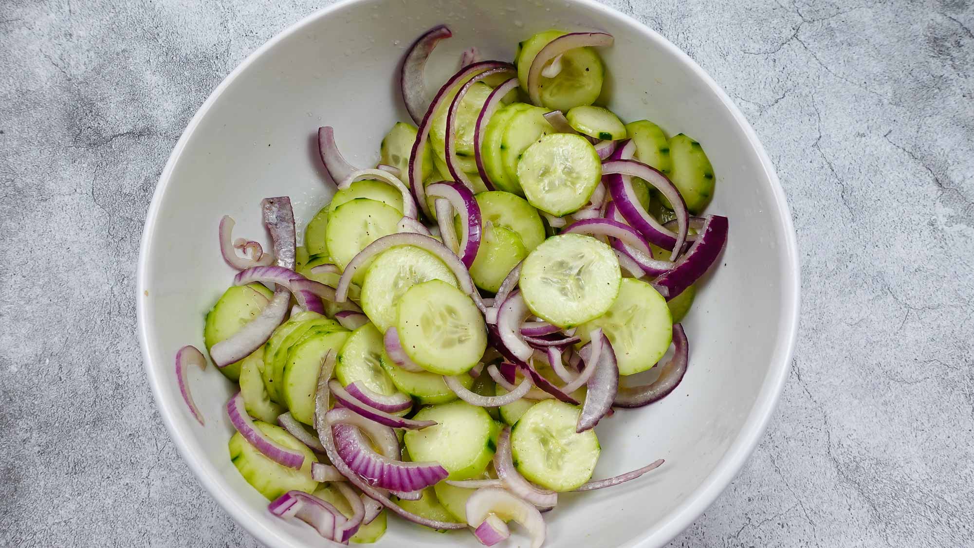 Cucumber Red Onion Salad Recipe in a big white bowl.
