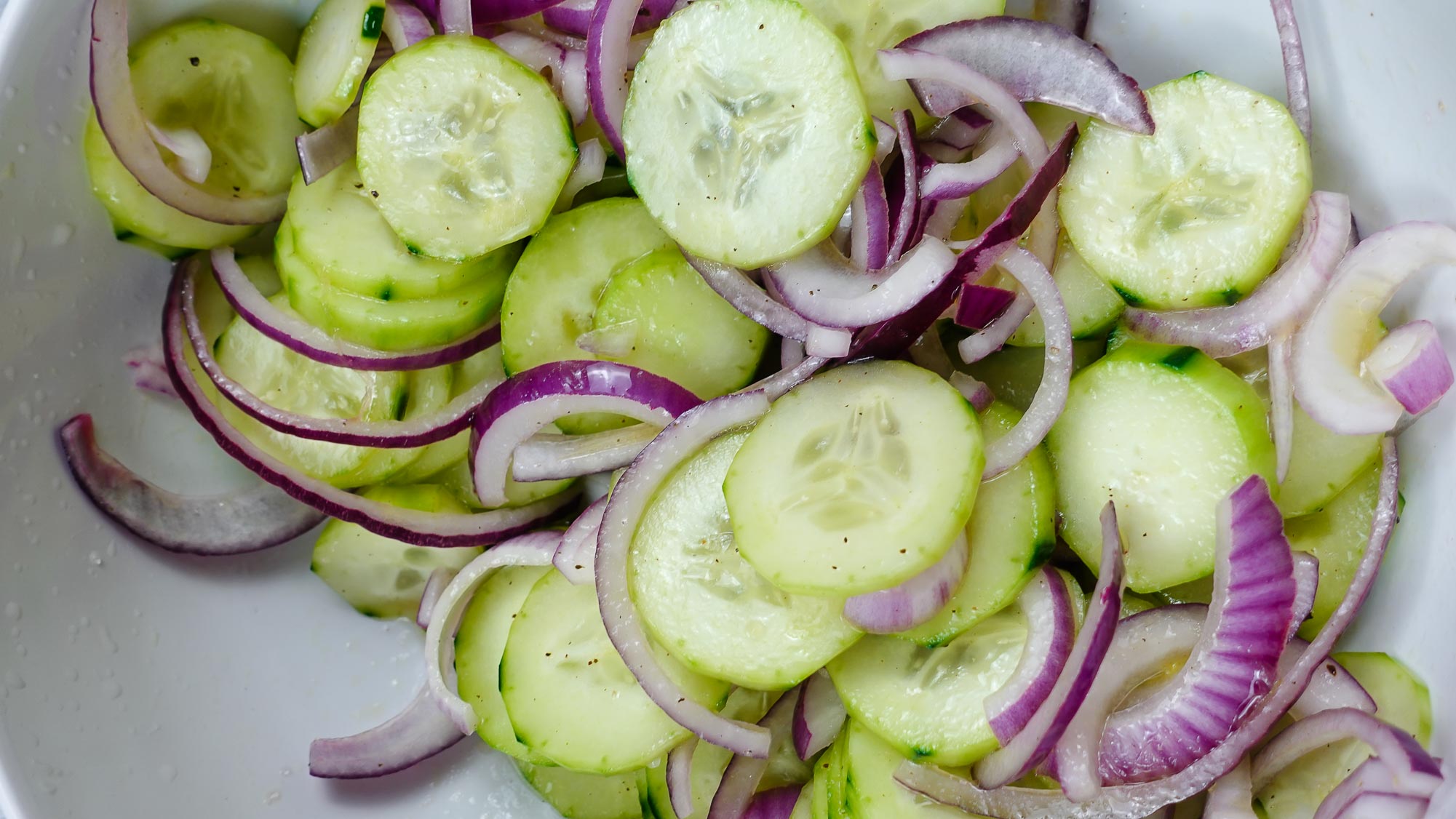 Cucumber Red Onion Salad Recipe in a big white bowl.