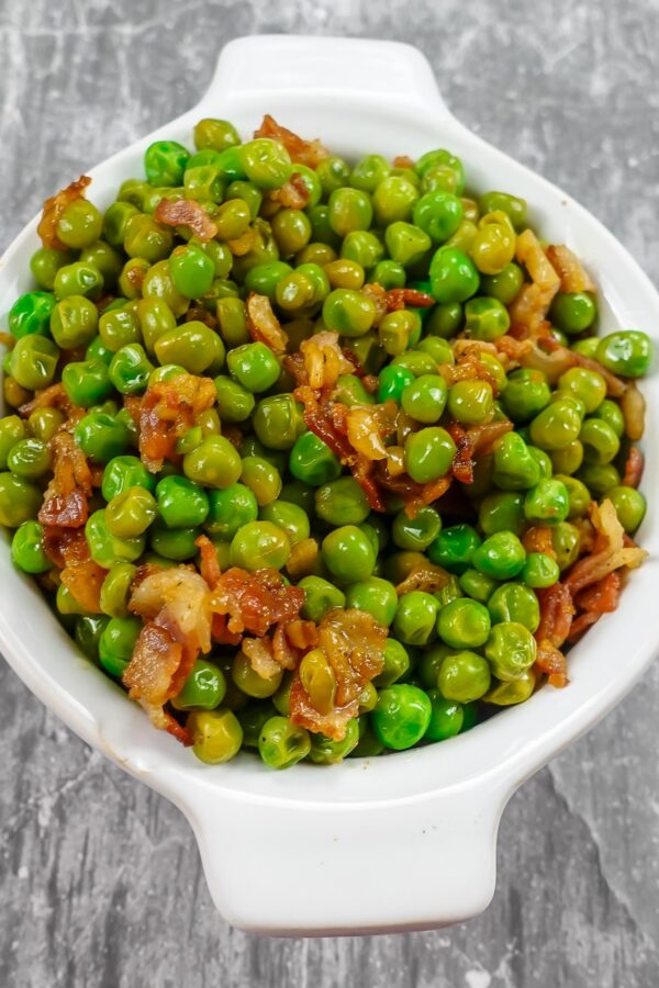 Mediterranean Peas with Bacon in a white bowl.