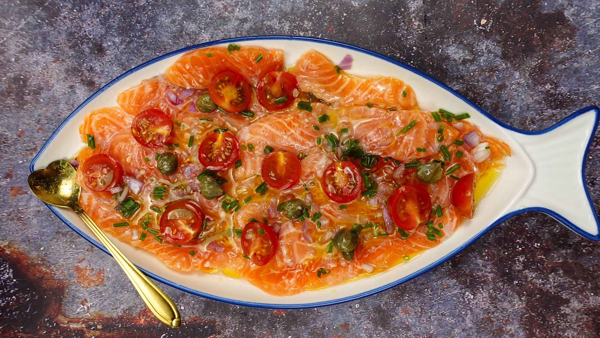 Fresh Salmon Carpaccio on a plate with a small spoon.