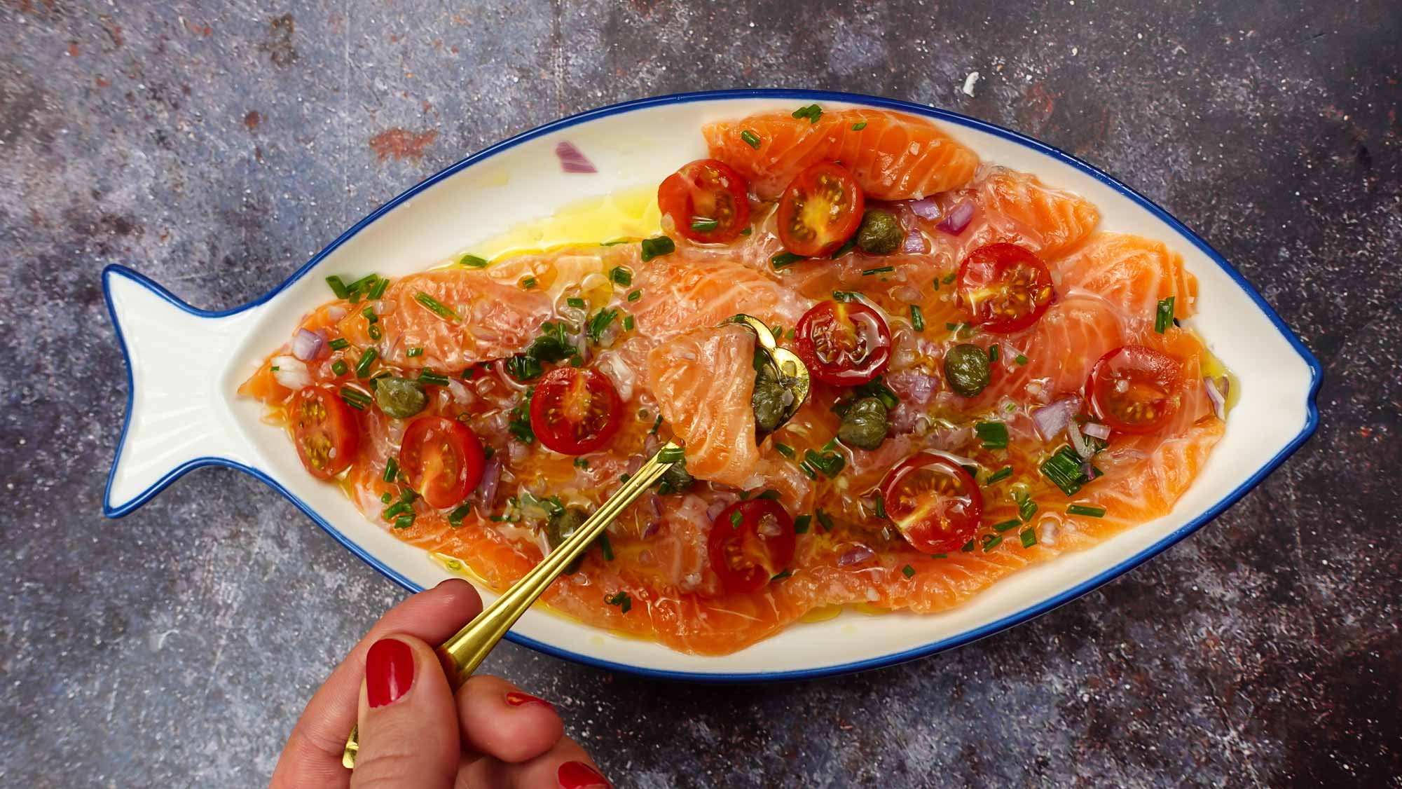 Fresh Salmon Carpaccio on a plate with a small spoon.