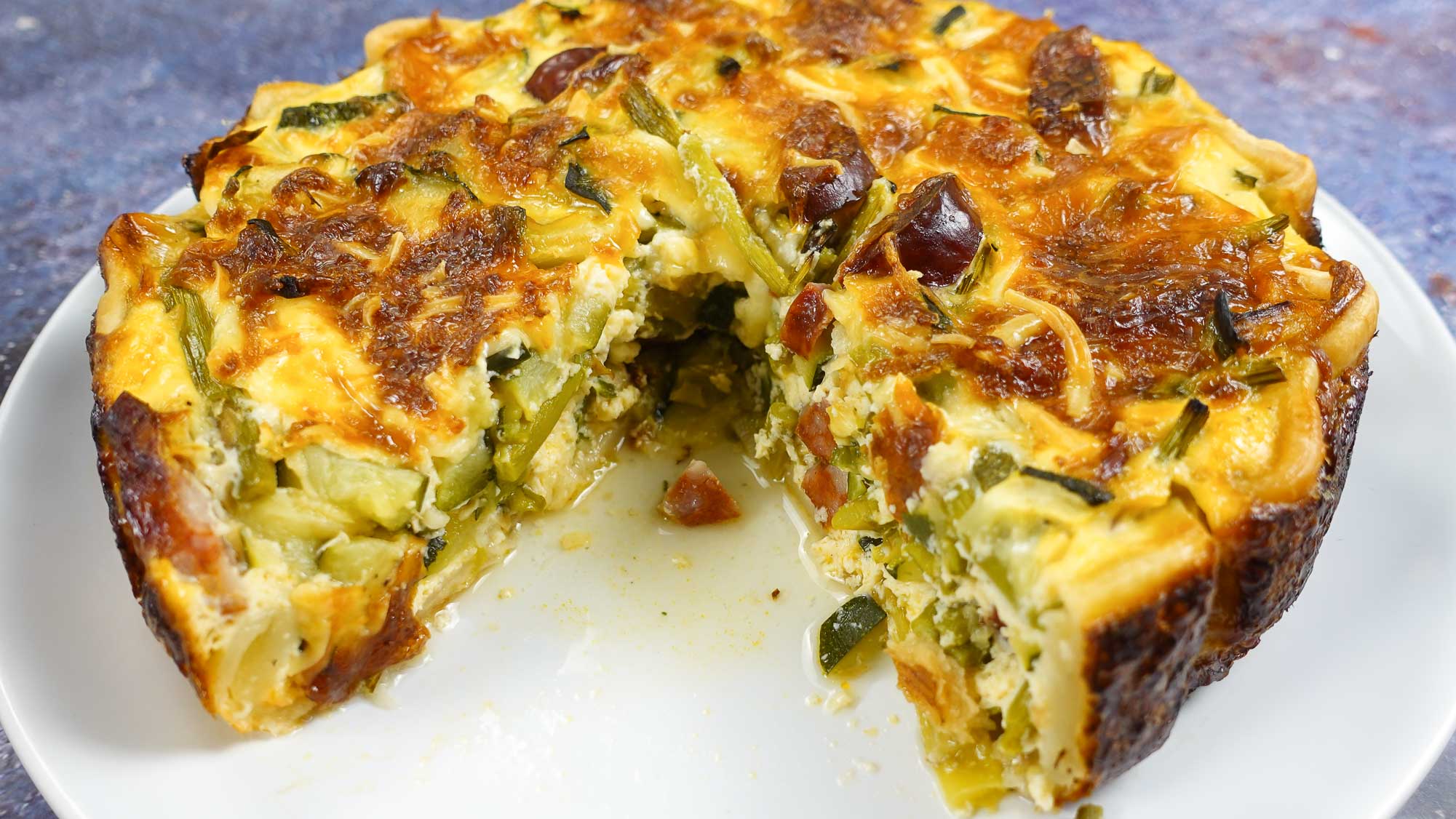 Juicy and mouthwatering quiche on a plate. 