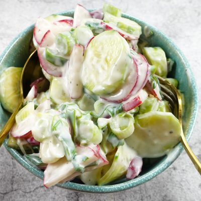 Creamy Cucumber Radish Salad in a blue bowl.